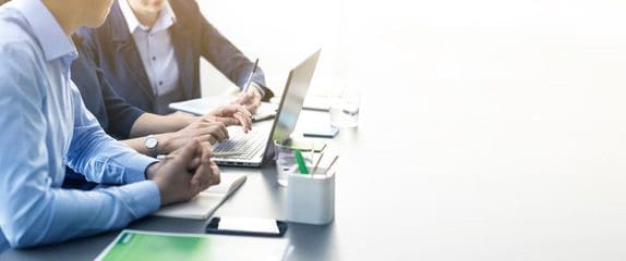 Two business people sitting at a laptop