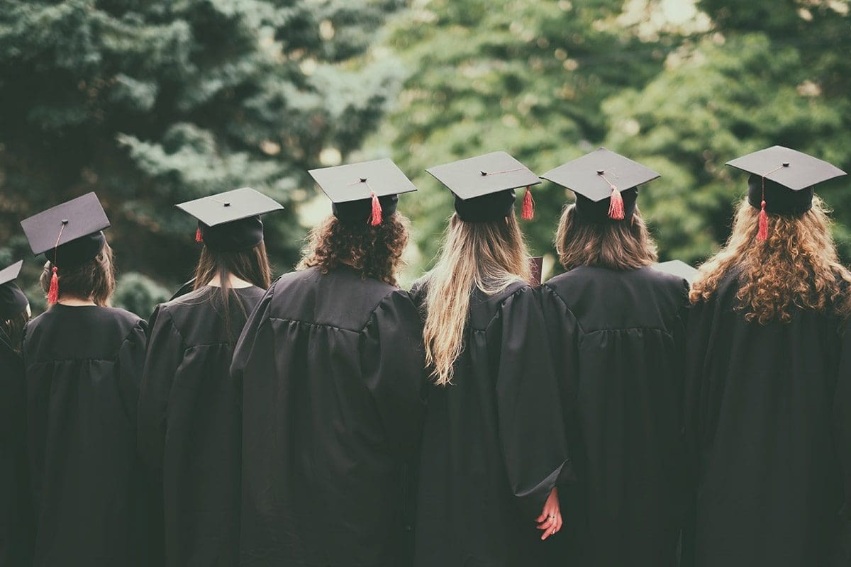 college graduates standing together